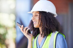 A construction worker talking on phone